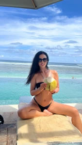 Enjoying the sun coconut and thinking of you would you like to be here