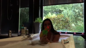 Lucy plays with the water gun happily in the bathroom