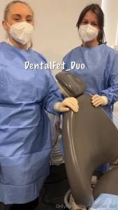The two nurses stand proudly in front of you wearing full surgical