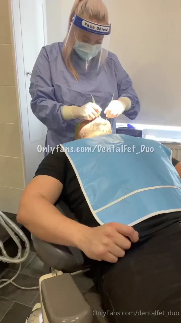 Amy in surgical gown visor and gloves giving a checkup and some 
