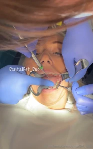 Kate taking a real close look at her colleague amy s dental work