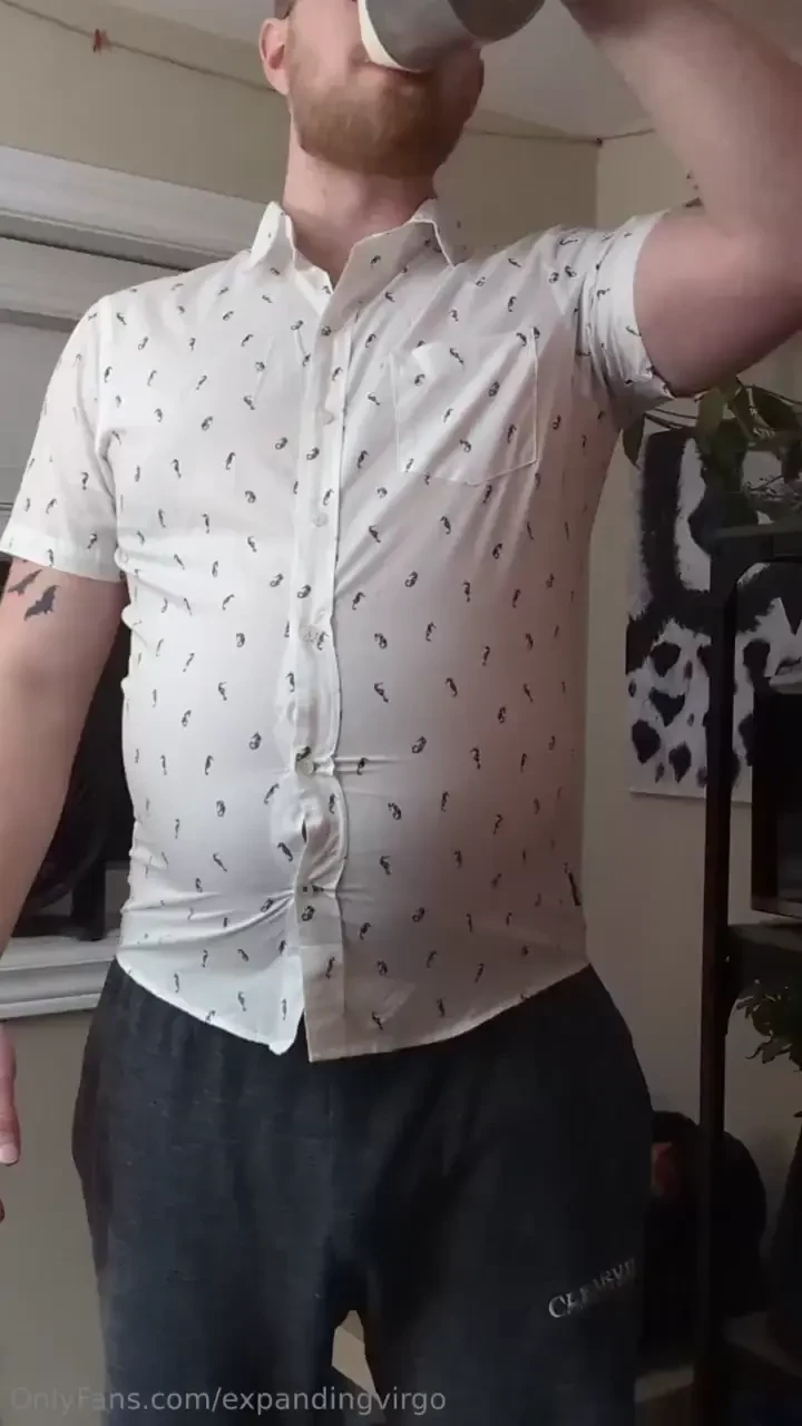 Tight shirt chugging drinking juice and milk on a half full belly 