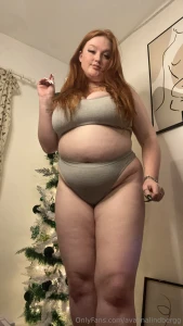 Dont let my belly distract u from the beautifull christmas tree behind