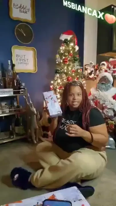 Playing with santa s gift under the tree 