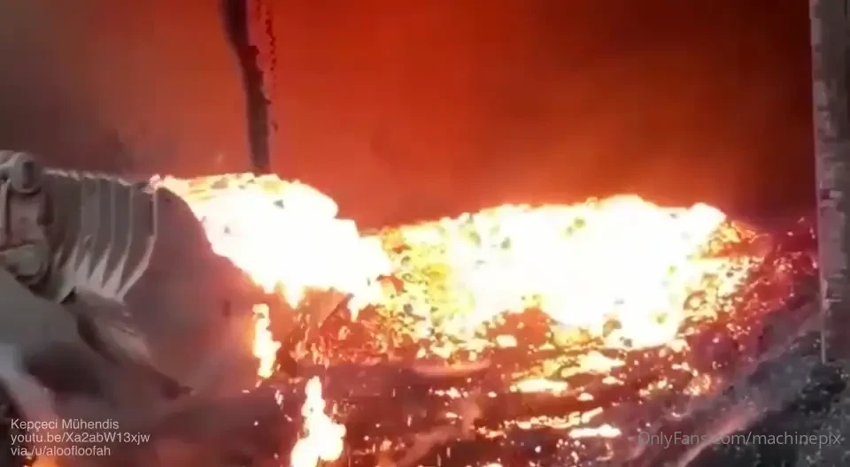 A front end loader with tire chains working at a steelworks via kep 