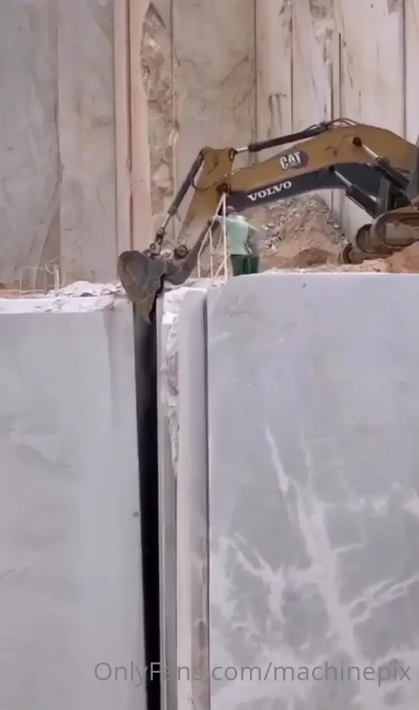 Quarrying marble with a cat and volvo excavator 
