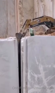 Quarrying marble with a cat and volvo excavator