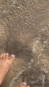 Experience a taste of pleasure at the beach with my white painted toes