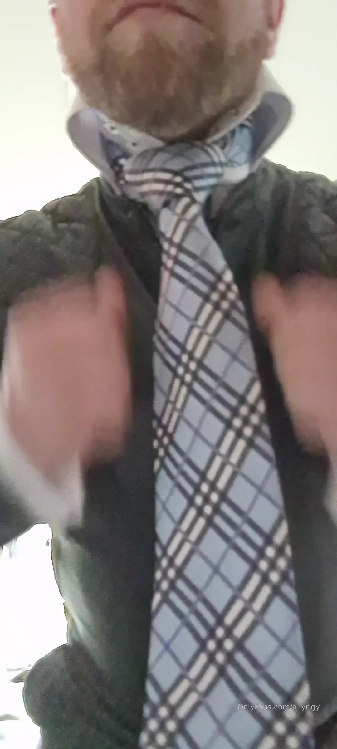 Leather jacket done all the way up with a high collar and tie on 